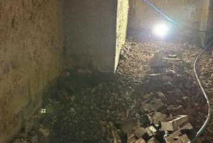 Basement with exposed soil and debris before waterproofing to resolve wet basement issues