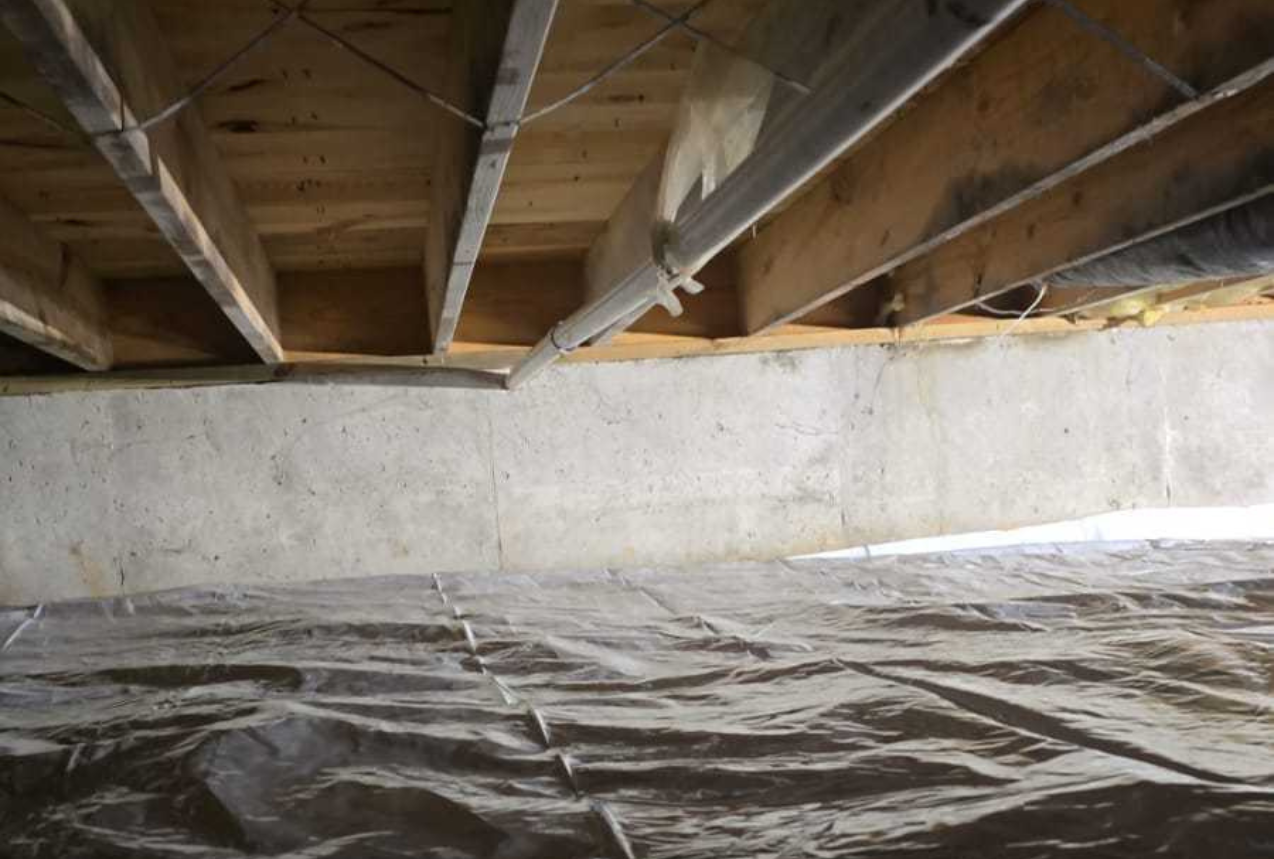 Crawl space dig out with installed floor joist support and vapor barrier