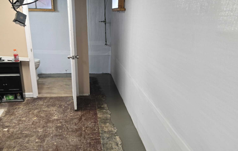 Finished interior wall with vapor barrier and drainage system to fix bowing walls