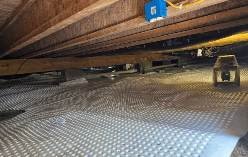 A professionally encapsulated crawl space with a dehumidifier, preventing wood damage in crawl space.